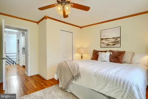 a bedroom with a bed and painting on the wall