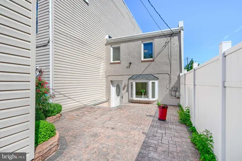 a front view of a house with a yard and potted plants