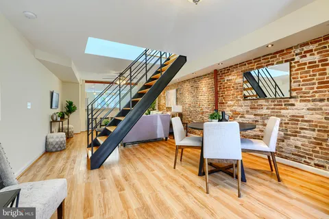 a dining room with furniture and wooden floor