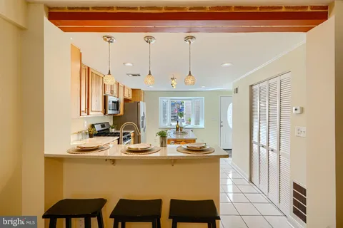 a dining room with furniture and a chandelier