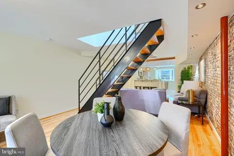 a dining room with furniture and wooden floor
