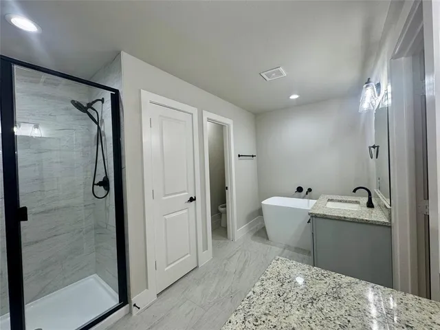 a spacious bathroom with a bathtub and sink