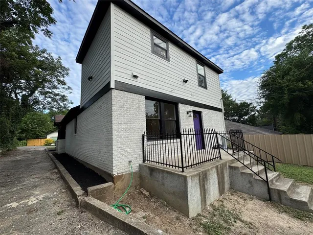 a front view of a house with deck and outdoor seating