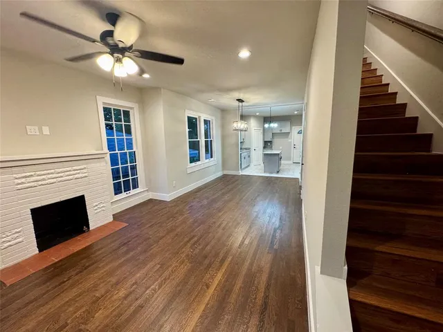 wooden floor in an empty room with a fireplace