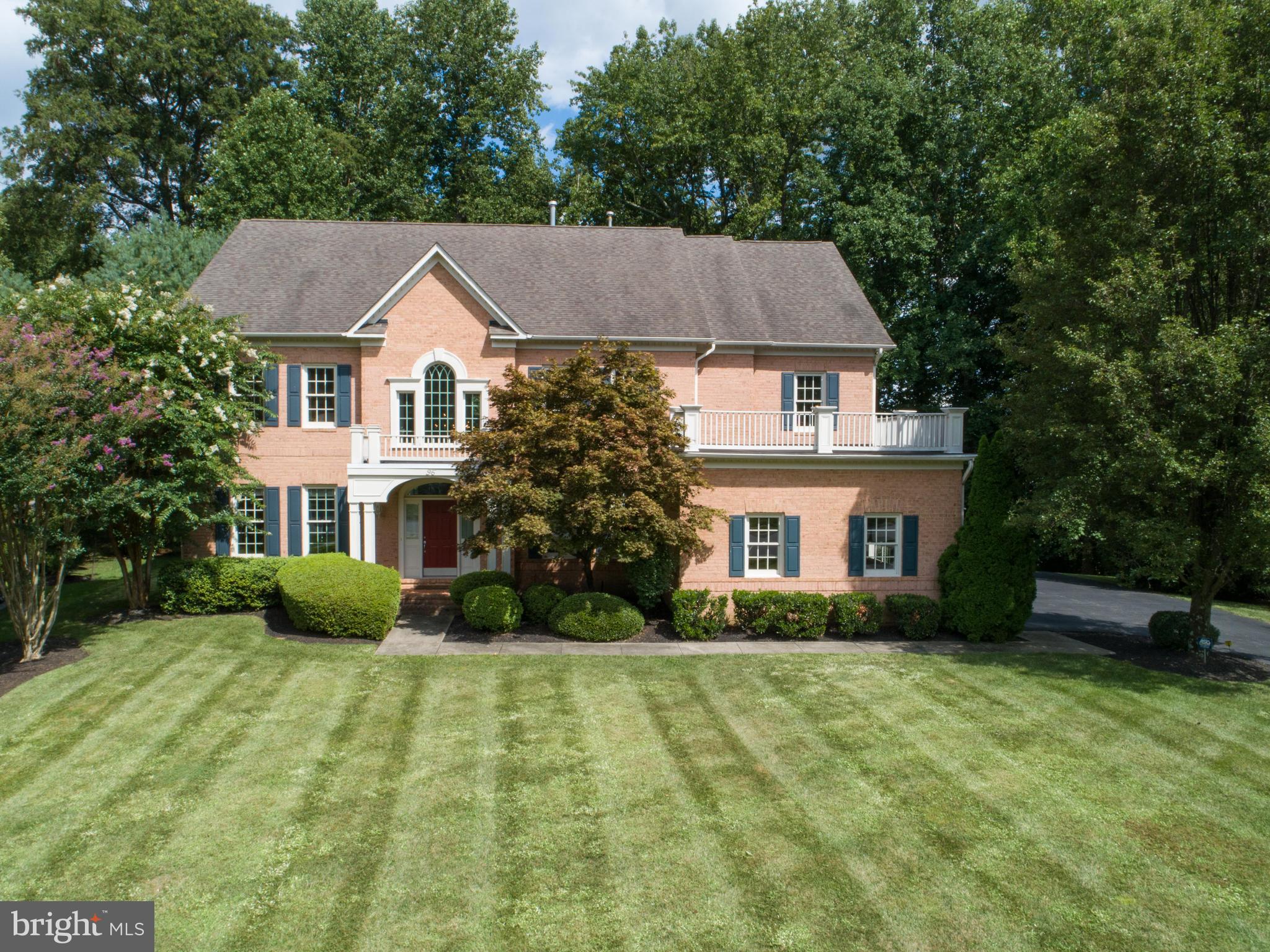 a aerial view of a house next to a yard