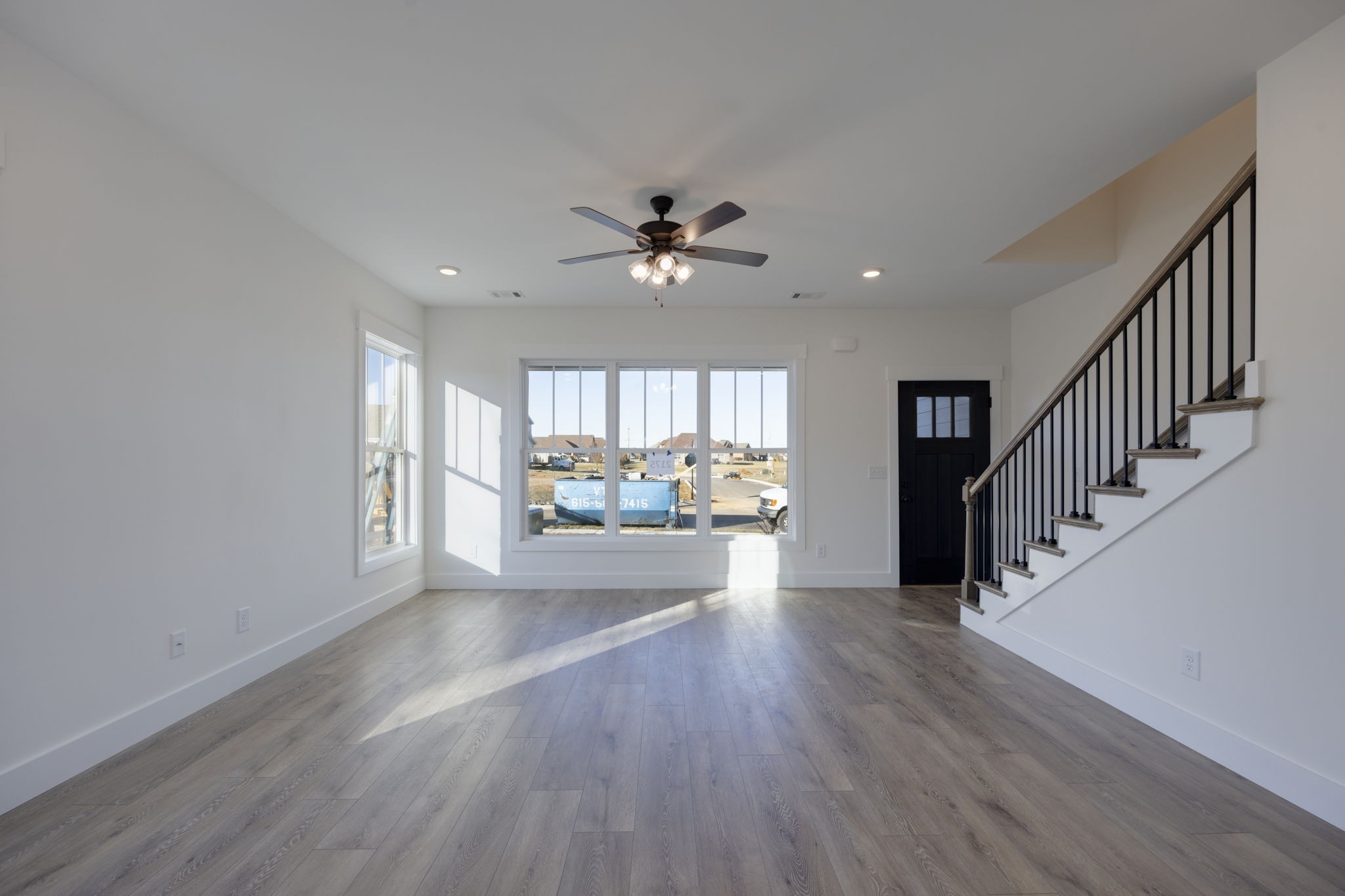 2175 Rylee Way Greenbrier, TN 37073 - Photo 4 of 17 a view of an empty room with wooden floor and a window