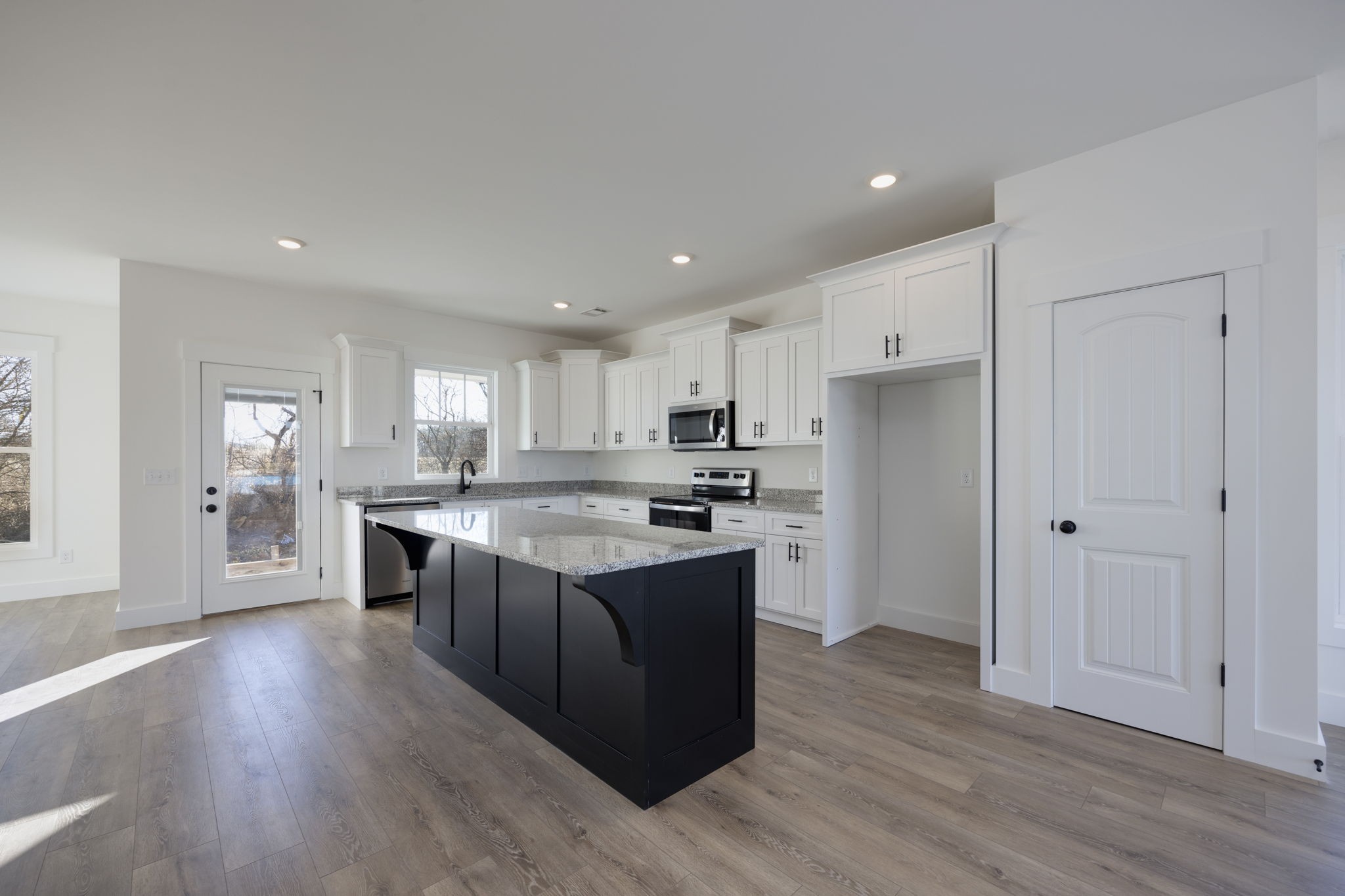 2175 Rylee Way Greenbrier, TN 37073 - Photo 8 of 17 a large kitchen with stainless steel appliances granite countertop a large counter top and wooden floors