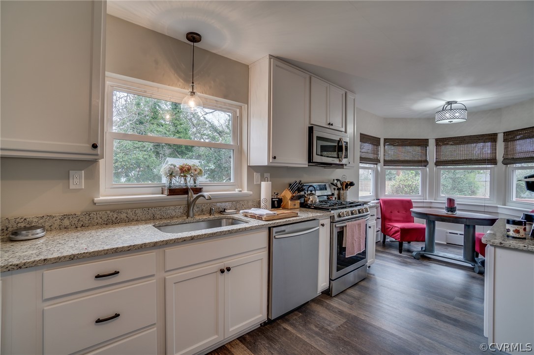 58 Alleghany Road Hampton, VA 23661 - Photo 14 of 39 a kitchen with granite countertop stainless steel appliances a stove sink and microwave