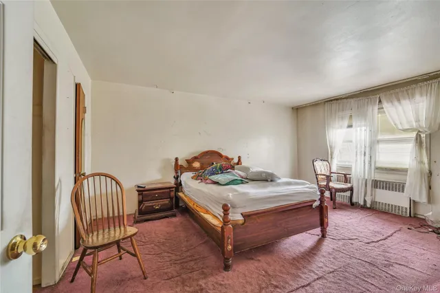 a bedroom with a bed and a chair