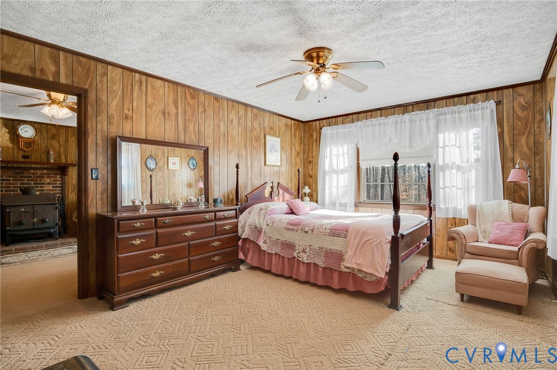 475 Dove Road Boydton, VA 23917 - Photo 23 of 45 a bedroom with a bed a chandelier and dresser