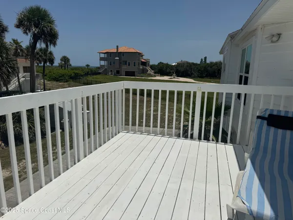 a balcony with wooden floor and fence