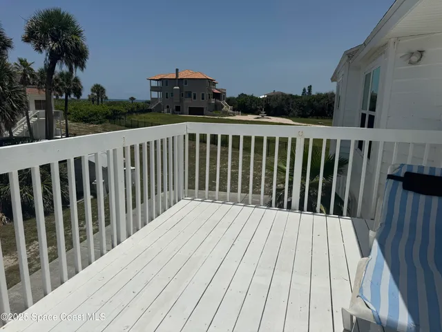 a balcony with wooden floor and fence