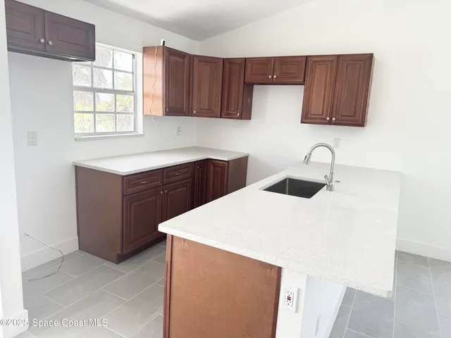 a kitchen with a cabinets and window