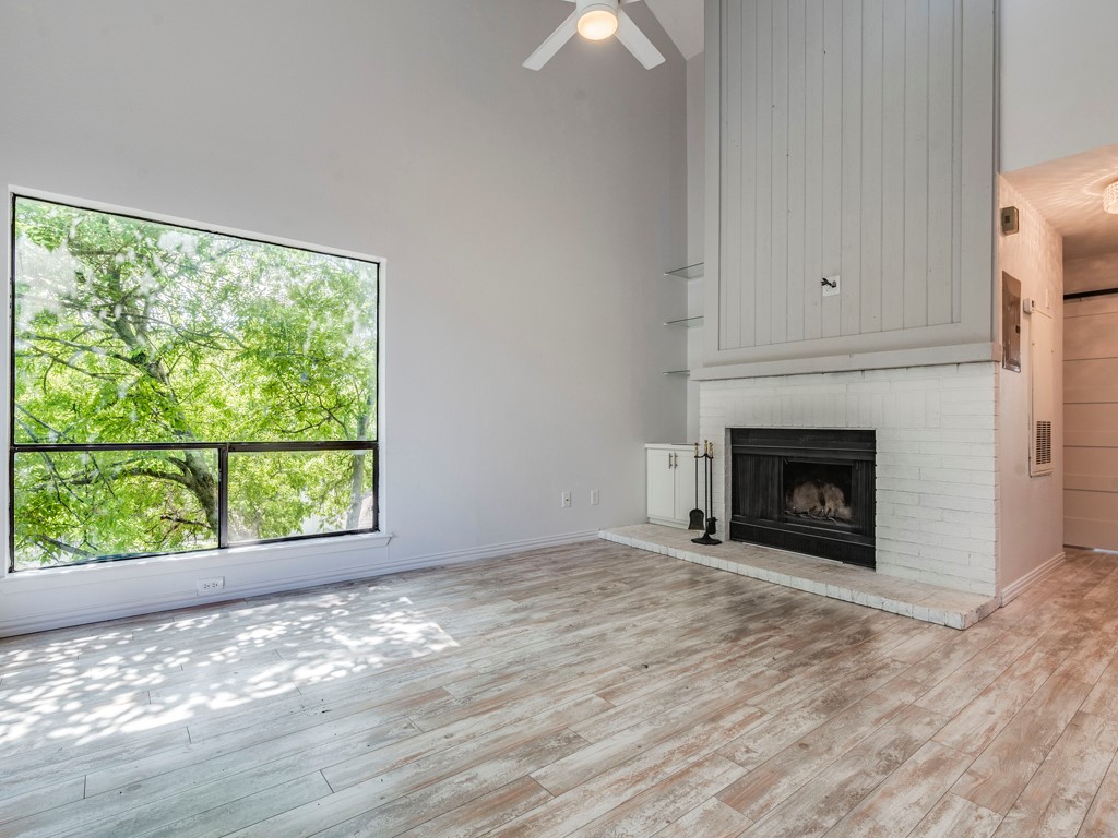 a view of empty room with window and fireplace