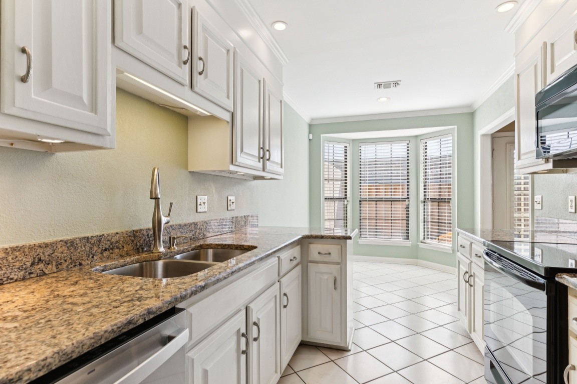 509 General George Patton Road Nashville, TN 37221 - Photo 3 of 25 a kitchen with stainless steel appliances granite countertop a sink stove and cabinets