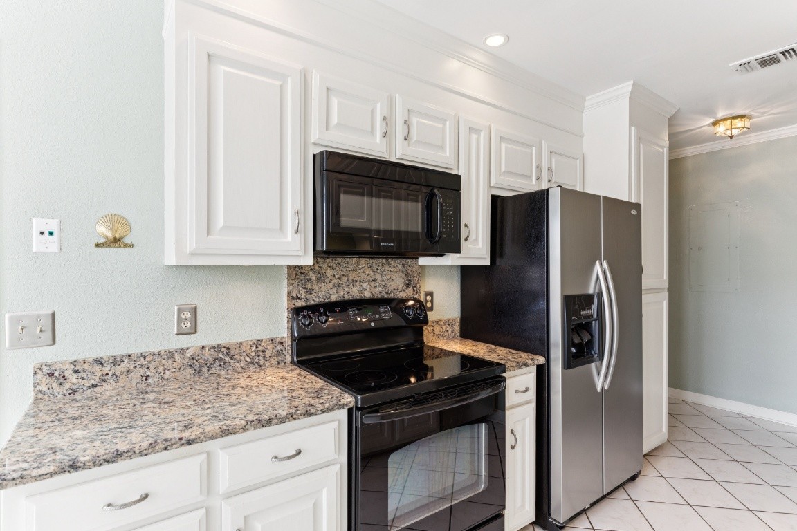 509 General George Patton Road Nashville, TN 37221 - Photo 4 of 25 a kitchen with granite countertop white cabinets and stainless steel appliances