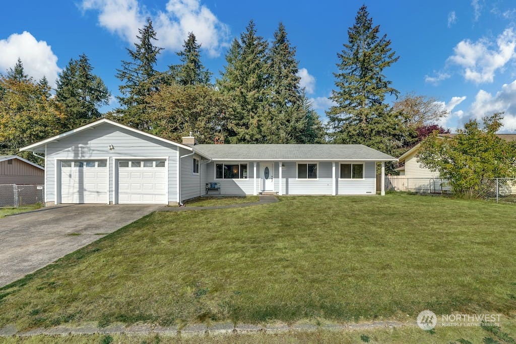 10050 Southeast 190th Street Renton, WA 98055 - Photo 1 of 27 a front view of a house with a garden