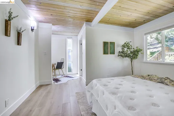 a bedroom with a bed and a potted plant