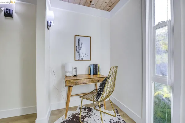 a view of a dining room with furniture and a potted plant