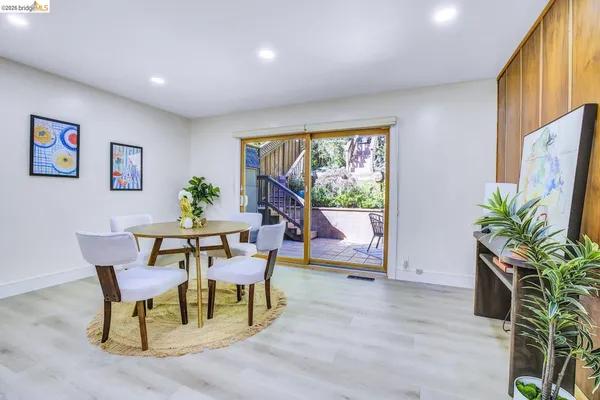 a dining room with furniture and a floor to ceiling window