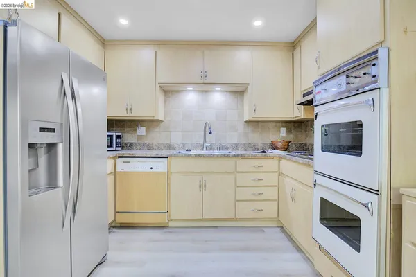 a kitchen with cabinets stainless steel appliances and counter space