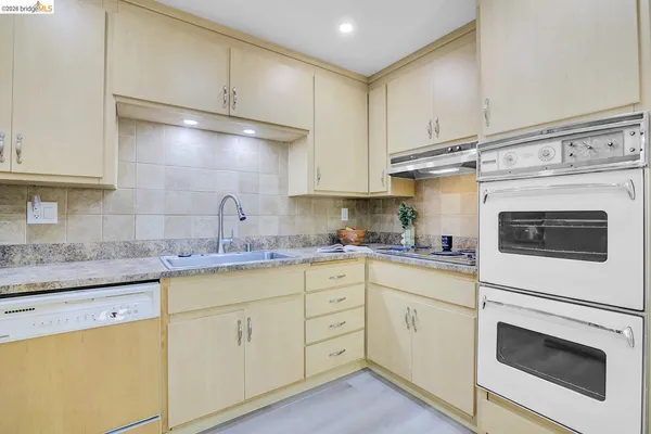 a kitchen with cabinets appliances and a sink
