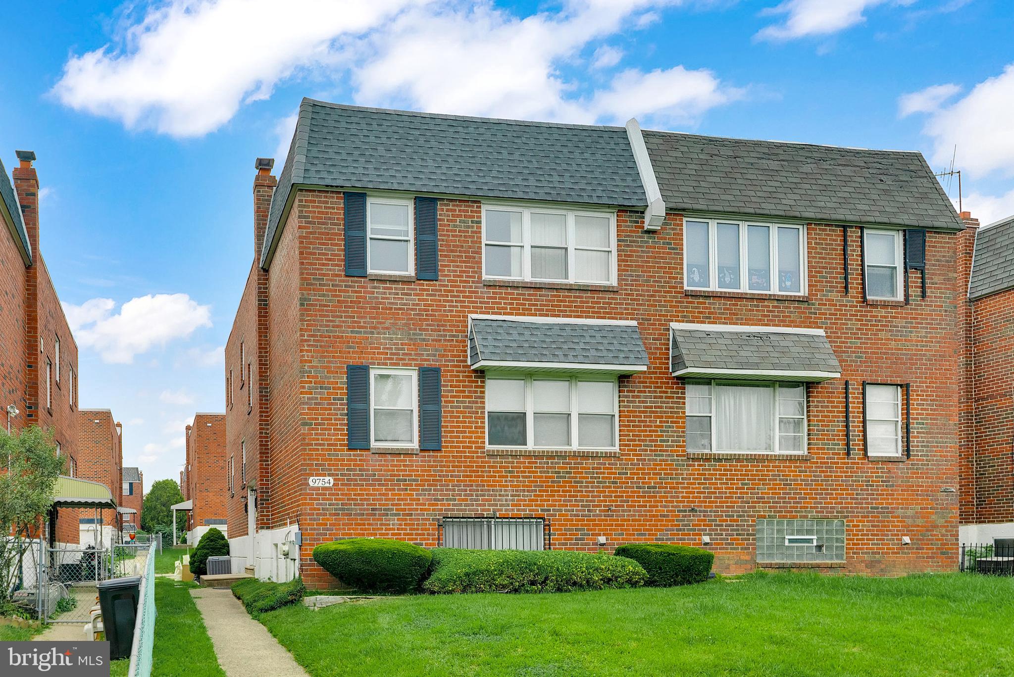 9754 East Roosevelt Boulevard, Unit 1 Philadelphia, PA 19115 - Photo 1 of 30 a front view of a house with a yard