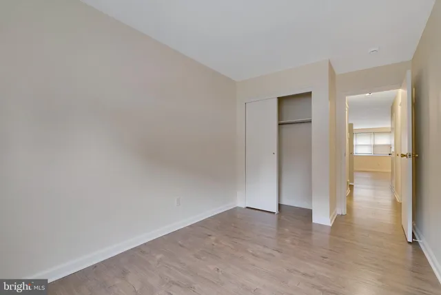 a view of wooden floor and windows in a room