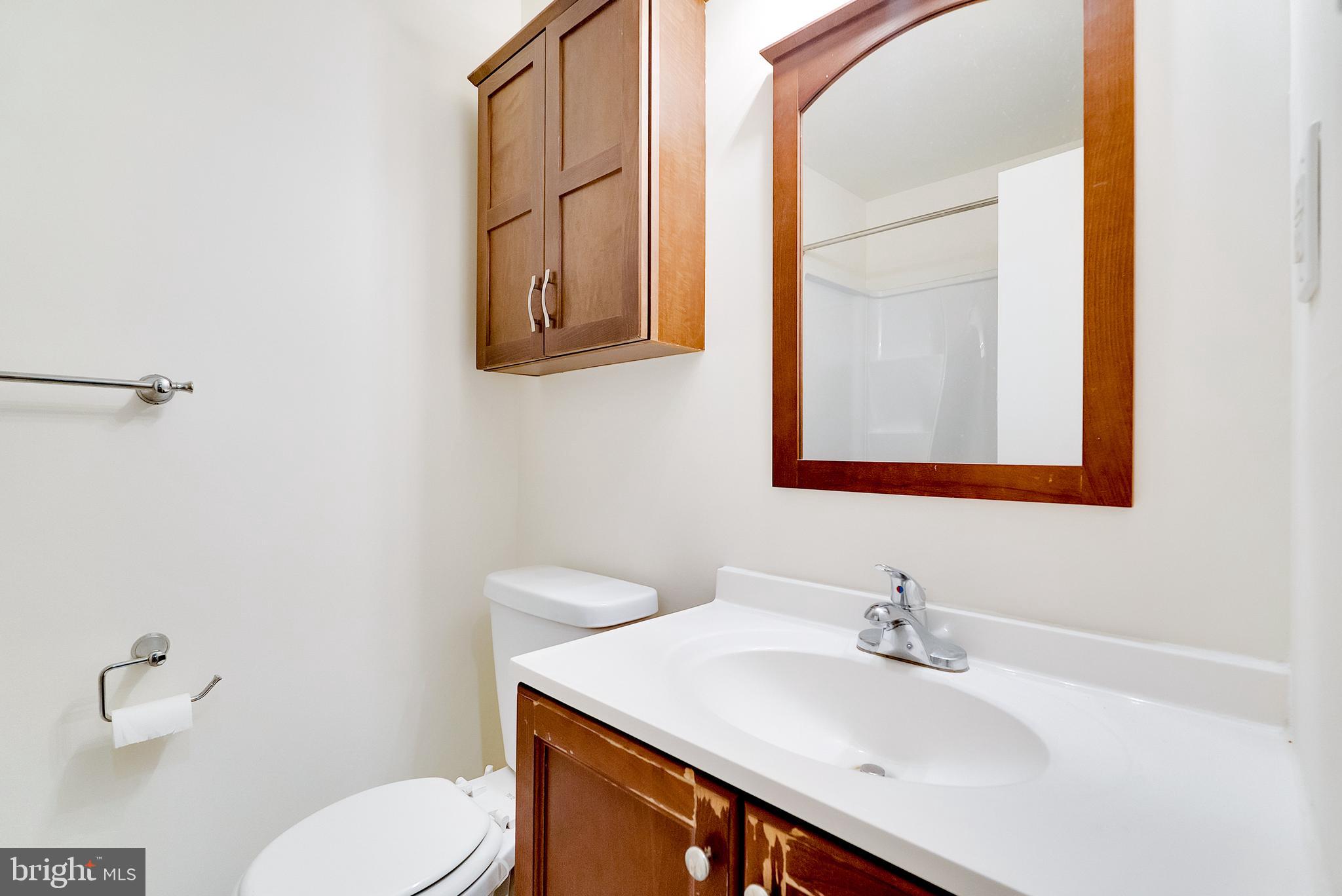 9754 East Roosevelt Boulevard, Unit 1 Philadelphia, PA 19115 - Photo 20 of 30 a bathroom with a sink vanity mirror and toilet