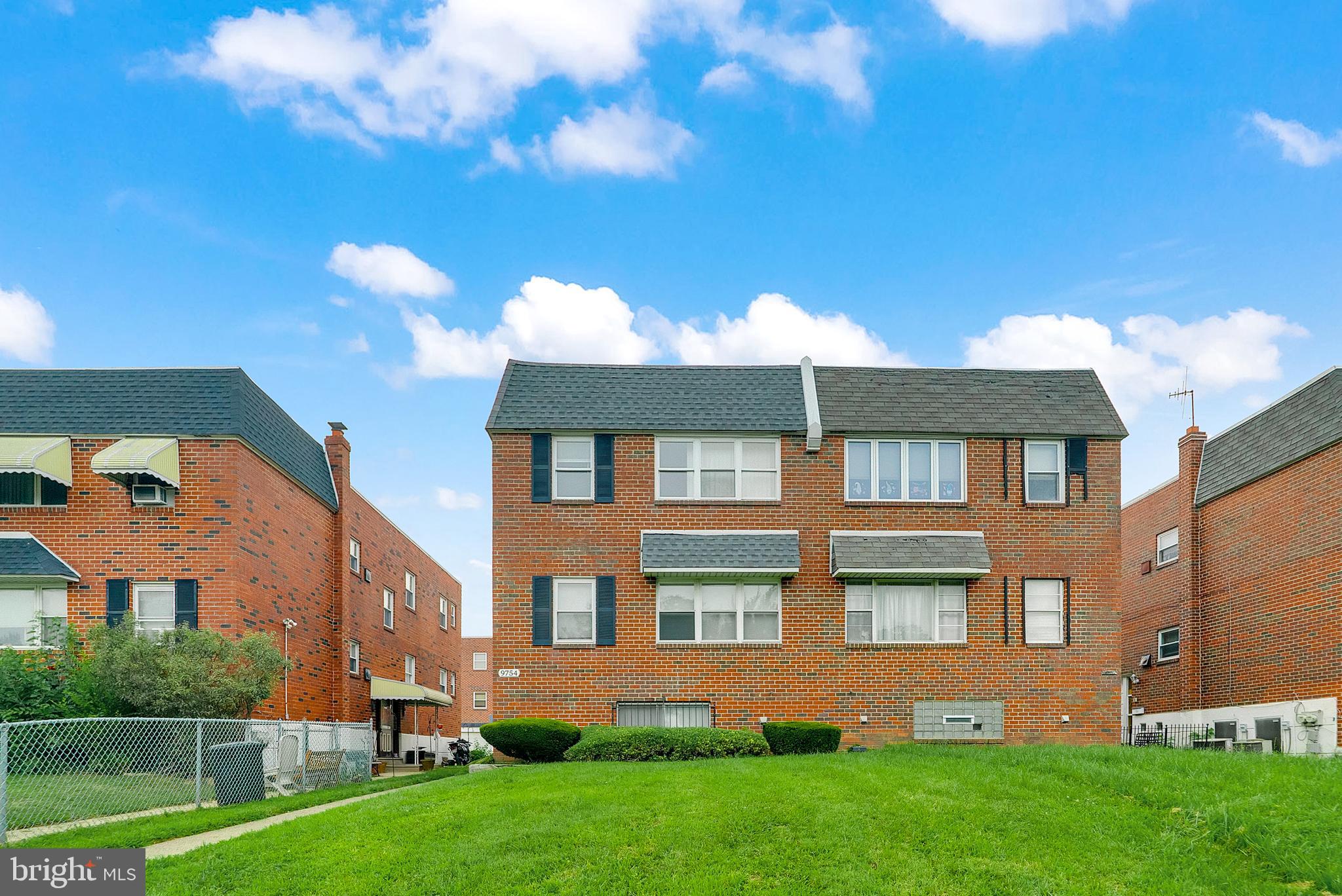9754 East Roosevelt Boulevard, Unit 1 Philadelphia, PA 19115 - Photo 2 of 30 a front view of a house with a yard