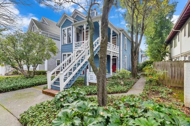 a view of a house with brick walls and a flower garden