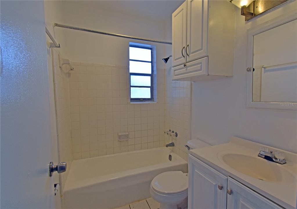 421 Briarwood Lane Spring Hill, FL 34606 - Photo 12 of 17 a bathroom with a bathtub shower sink vanity and toilet