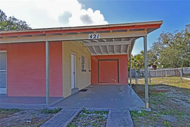 a view of a house with a small yard and plants