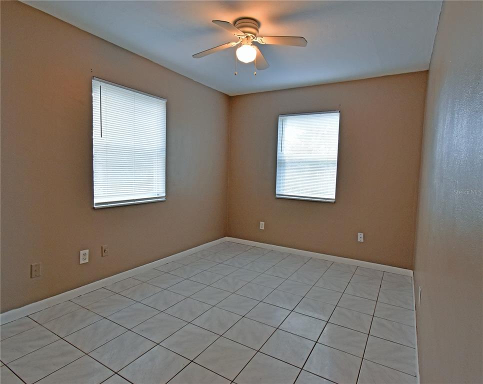 421 Briarwood Lane Spring Hill, FL 34606 - Photo 10 of 17 an empty room with windows and fan