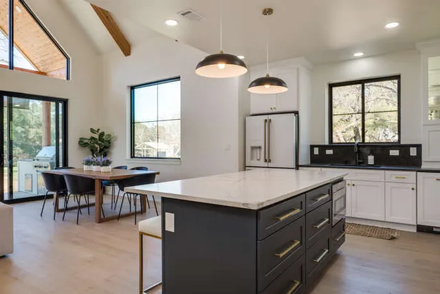 a kitchen with a table chairs sink and cabinets