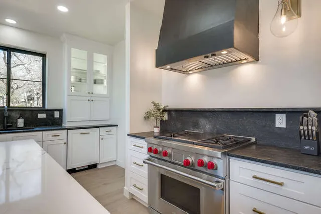 a kitchen with stainless steel appliances a sink and a stove