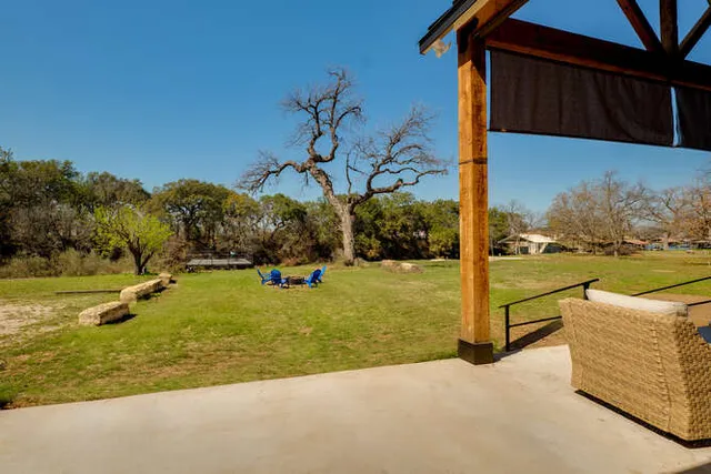 a view of a swimming pool with a chair and tables in the patio