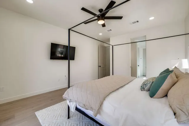 a bedroom with a bed and a flat screen tv