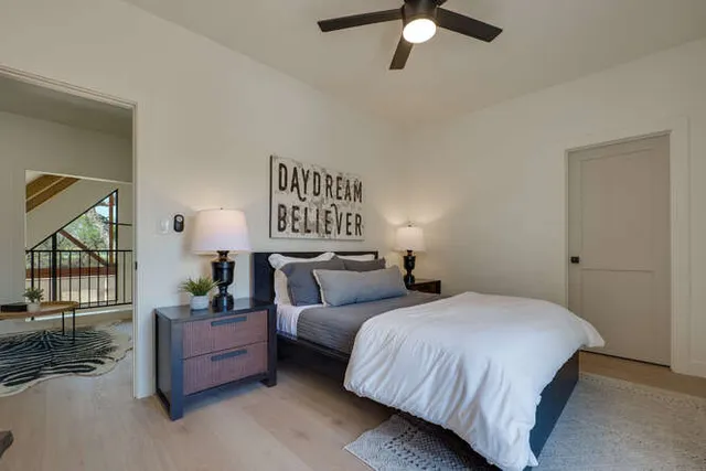 a bedroom with bed and a chandelier