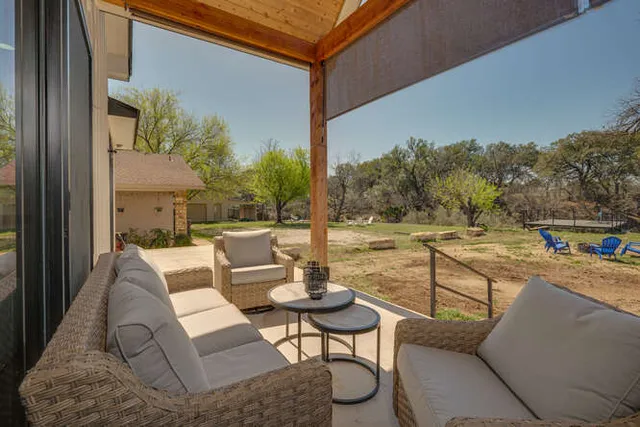 a balcony with table and chairs