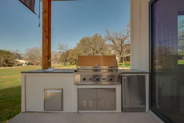 a stove top oven sitting inside of a kitchen
