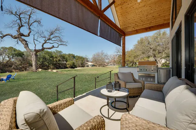 a view of a patio with couches table and chairs with a yard