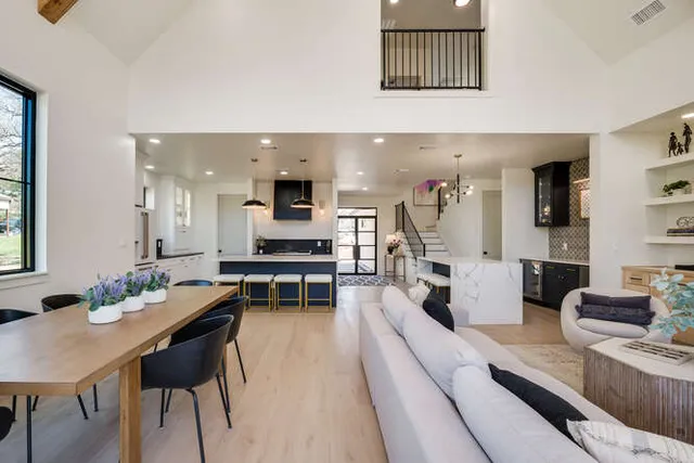 a living room with furniture and kitchen view