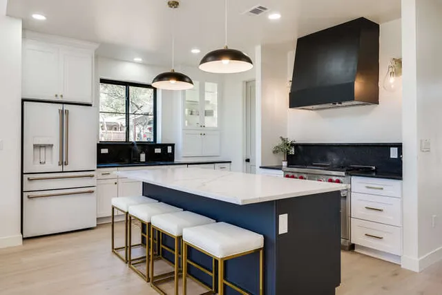 a kitchen with a table chairs refrigerator and microwave