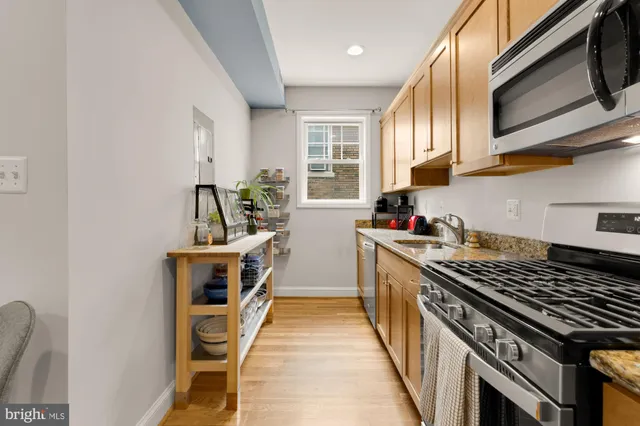 a kitchen with wooden cabinets and a stove top oven
