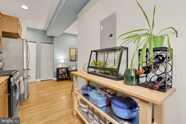 a kitchen with stainless steel appliances granite countertop a sink a stove and a refrigerator