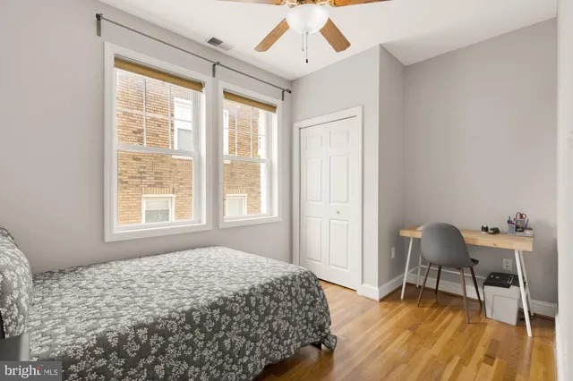 a bedroom with a bed and wooden floor