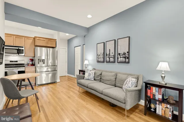 a kitchen with stainless steel appliances a refrigerator sink and cabinets