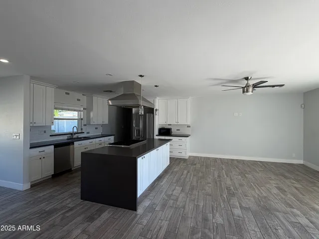a kitchen with granite countertop a stove top oven and sink