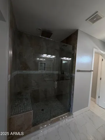 a bathroom with a glass shower door